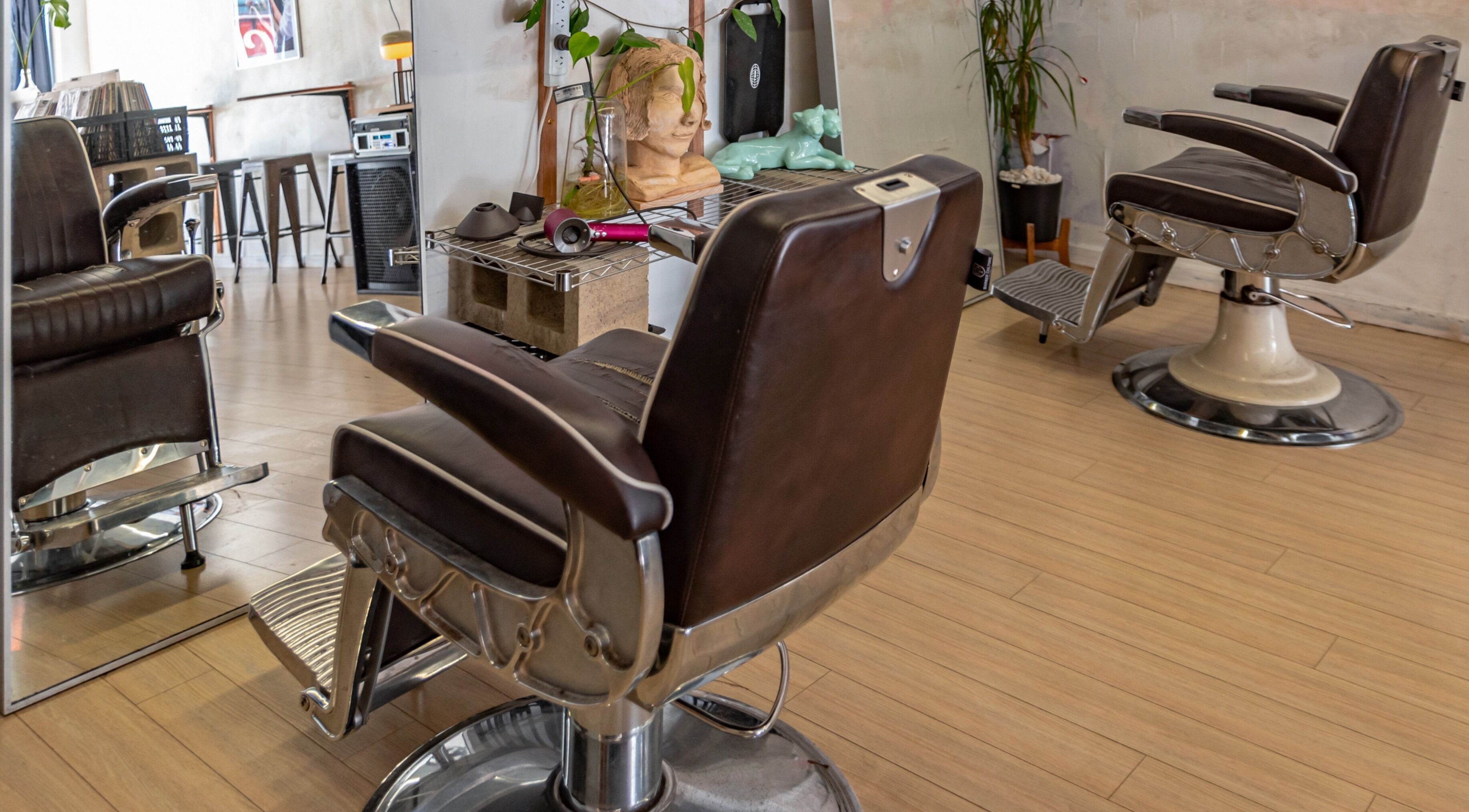Elegant salon chairs at The Royal Moody, Glenelg, South Australia, AU, showcasing modern beauty space.
