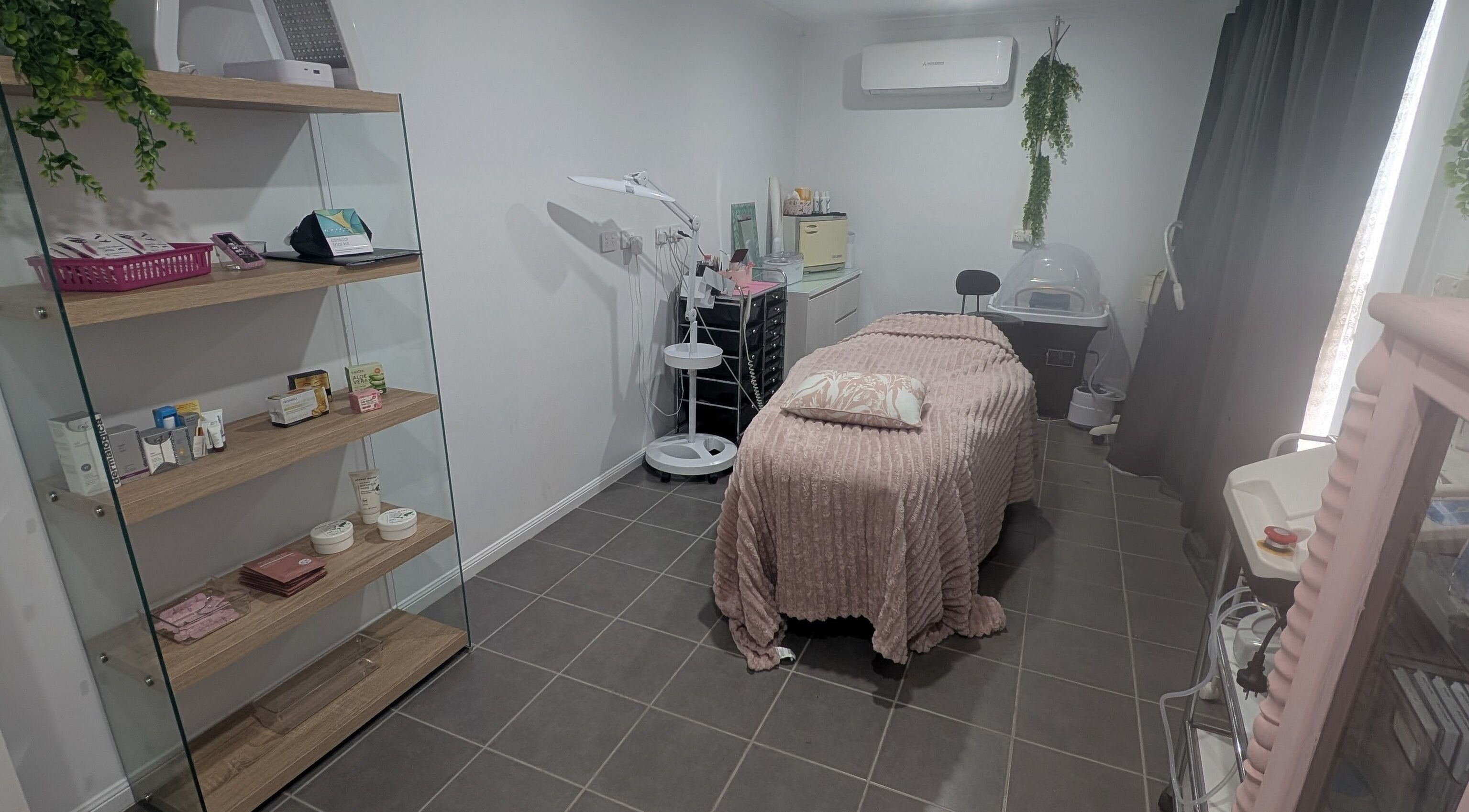Relaxing treatment room at Designs By Dally, Kelso, Queensland, AU with soft pink decor and elegant furnishings.