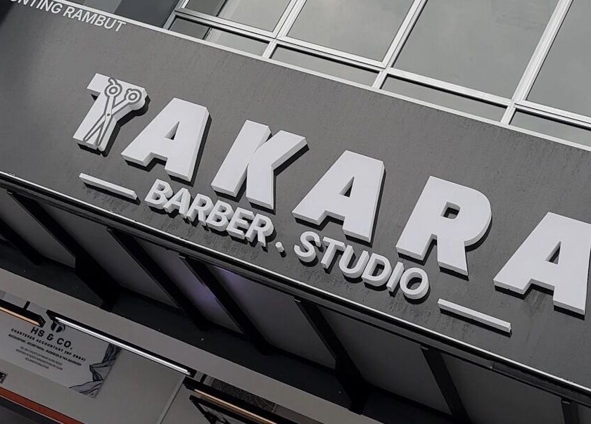 Takara Barbershop entrance in Puncak Alam, Selangor, MY showcasing sleek signage.