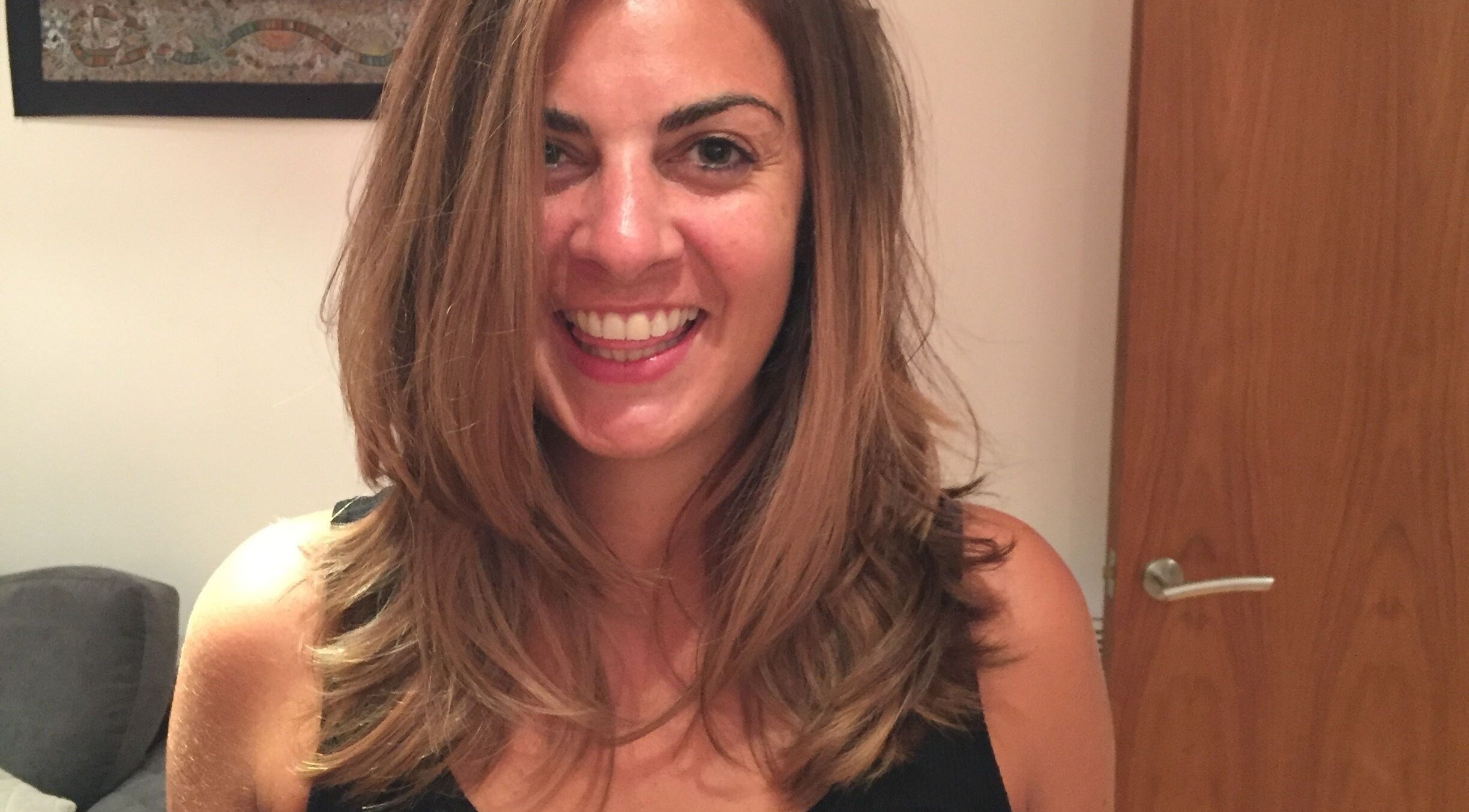 Smiling woman with styled hair at Arran & Emily Hair in Bury, England, GB.