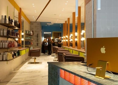 Interior elegante de Hair Cut Day Travessera en Barcelona, Catalunya, ES, mostrando estaciones de estilistas modernas.