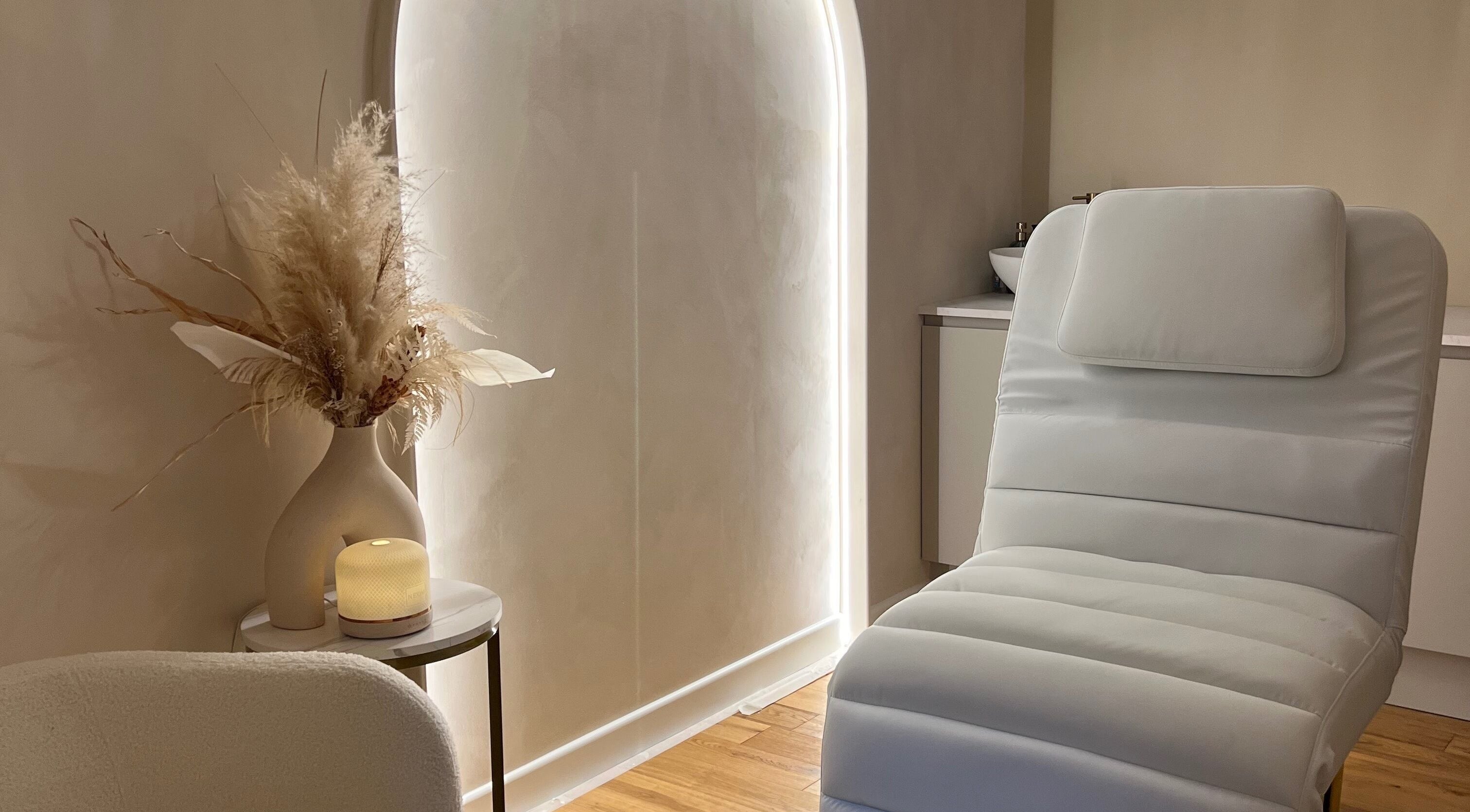 Relaxing treatment room at The House Of You, Cambridge, England, GB, with cozy chair and ambient décor.
