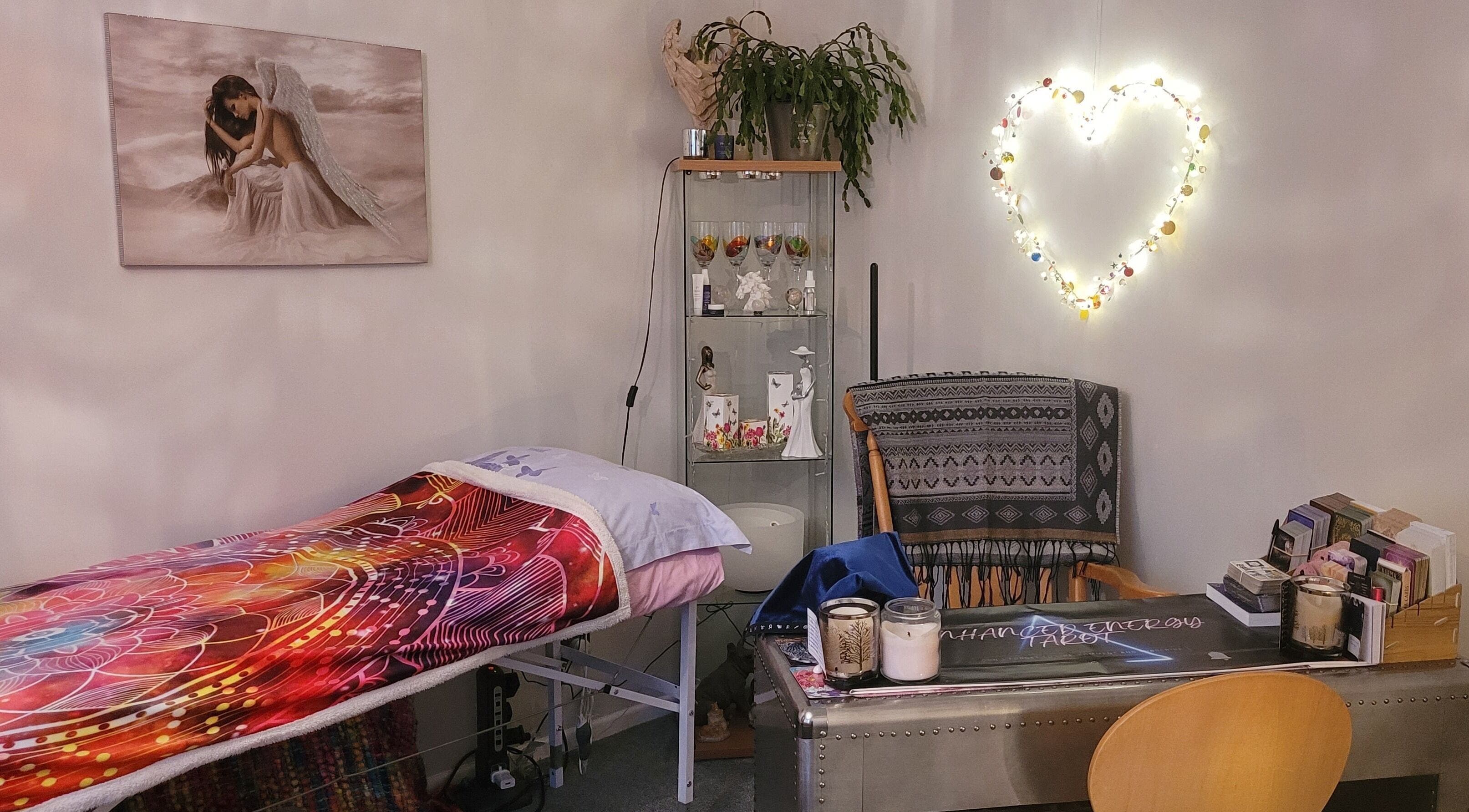 Cozy therapy room at Enhanced Energy Healing in Ferndown, England, GB with colorful decor and soft lighting.