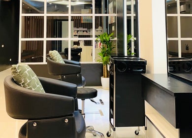 Modern salon interior at Nima Hair By Japanese, Parañaque, Metro Manila, PH with stylish chairs and decor.