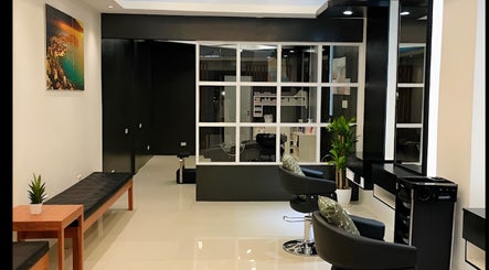 Interior view of Nima Hair By Japanese, Parañaque, Metro Manila, PH. Modern chairs and sleek design.