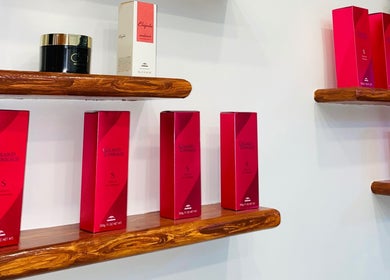 Red product boxes on wooden shelves at Nima Hair By Japanese, Parañaque, Metro Manila, PH.