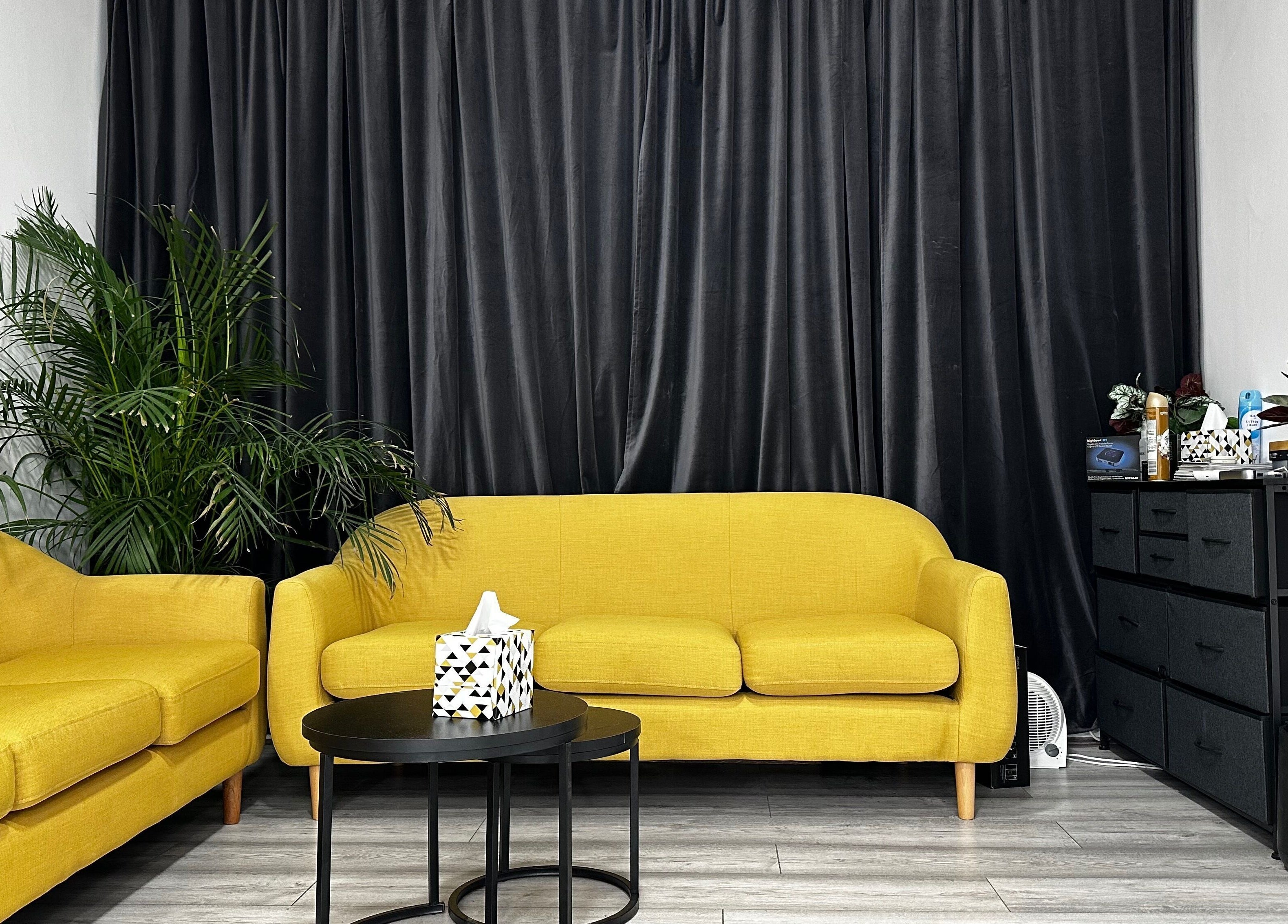 Cozy yellow sofas at Aries Salon Academy, London, England, GB, offering a chic, welcoming atmosphere.