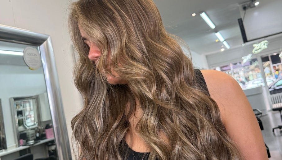 Lustrous wavy hair styled at Hair by Chelsea, Clydebank, Scotland, GB. Salon reflecting modern beauty trends.