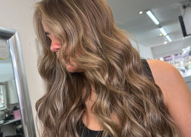 Lustrous wavy hair styled at Hair by Chelsea, Clydebank, Scotland, GB. Salon reflecting modern beauty trends.