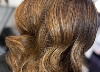 Elegant wavy hairstyle at Hair by Chelsea, Clydebank, Scotland, GB showcasing rich hair color.