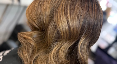 Elegant wavy hairstyle at Hair by Chelsea, Clydebank, Scotland, GB showcasing rich hair color.