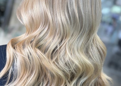 Blonde wavy hair styled at Hair by Chelsea in Clydebank, Scotland, GB, enhancing natural elegance.