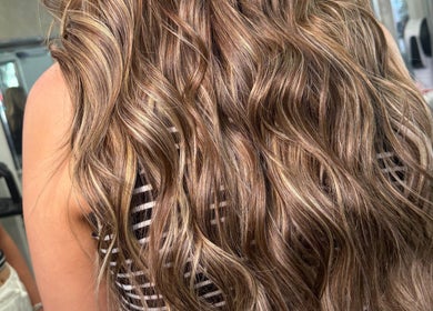 Glossy wavy hairstyle at Hair by Chelsea in Clydebank, Scotland, GB showcasing expert styling.