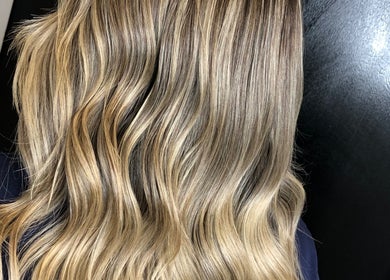 Blonde wavy hairstyle at Hair by Chelsea, Clydebank, Scotland, GB showcasing natural highlights.