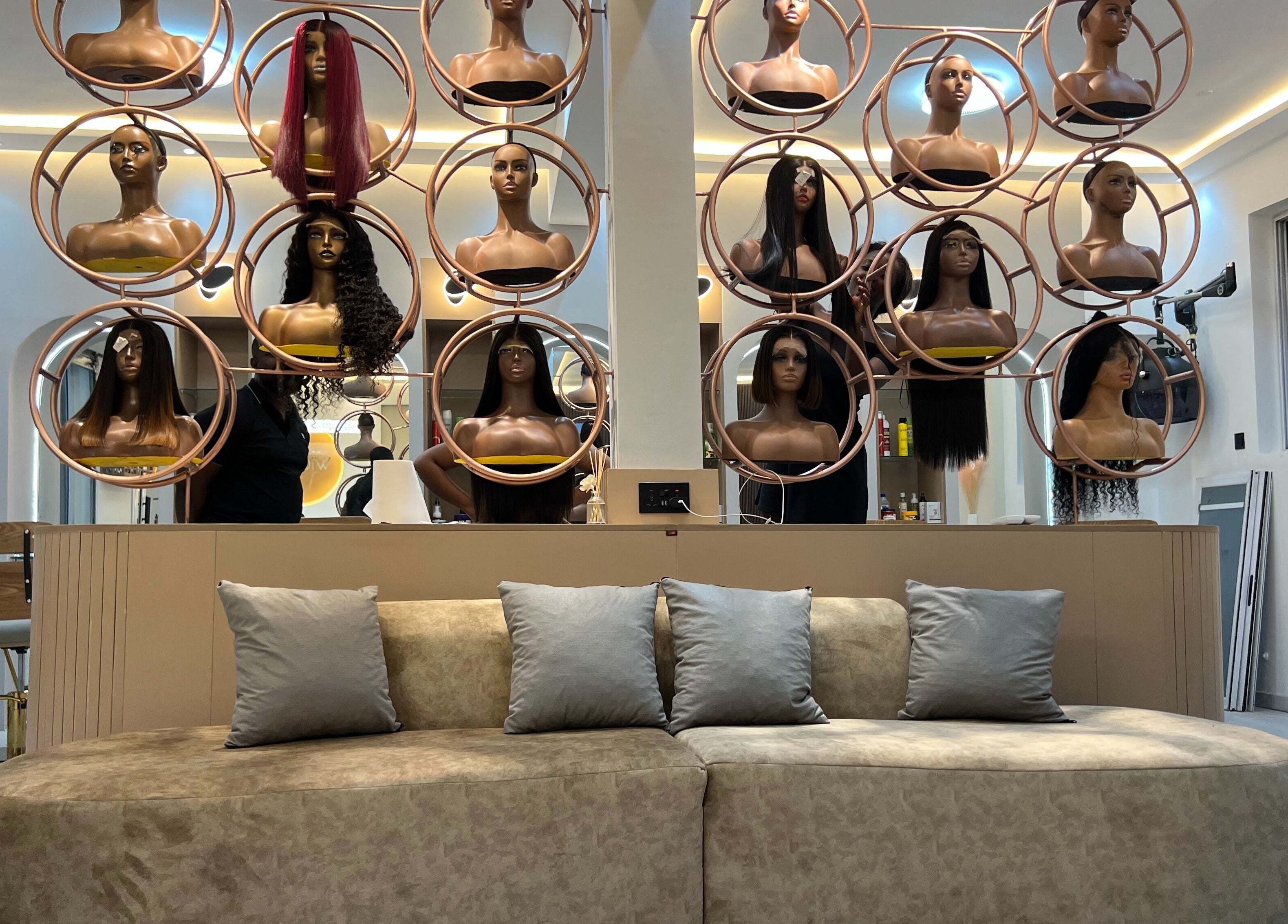 Wighub & Salon showcases stylish mannequin wigs in Accra, Greater Accra Region, GH, with chic seating area.