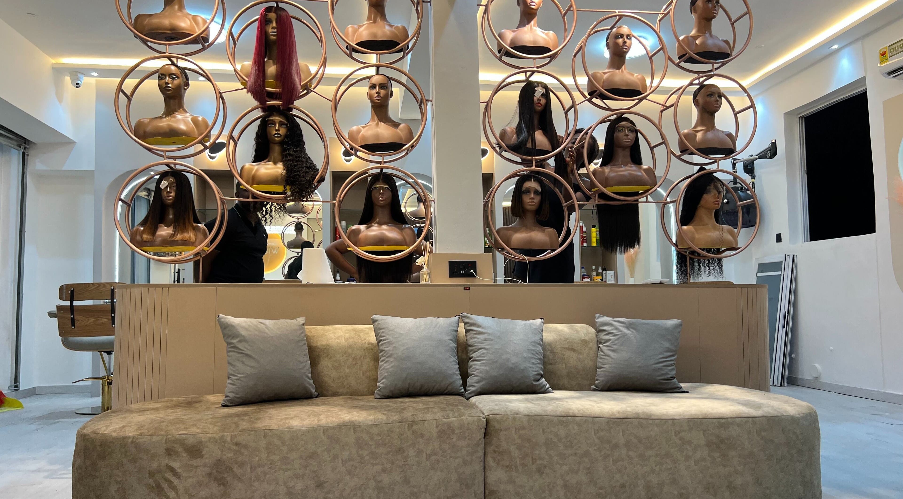 Wighub & Salon showcases stylish mannequin wigs in Accra, Greater Accra Region, GH, with chic seating area.