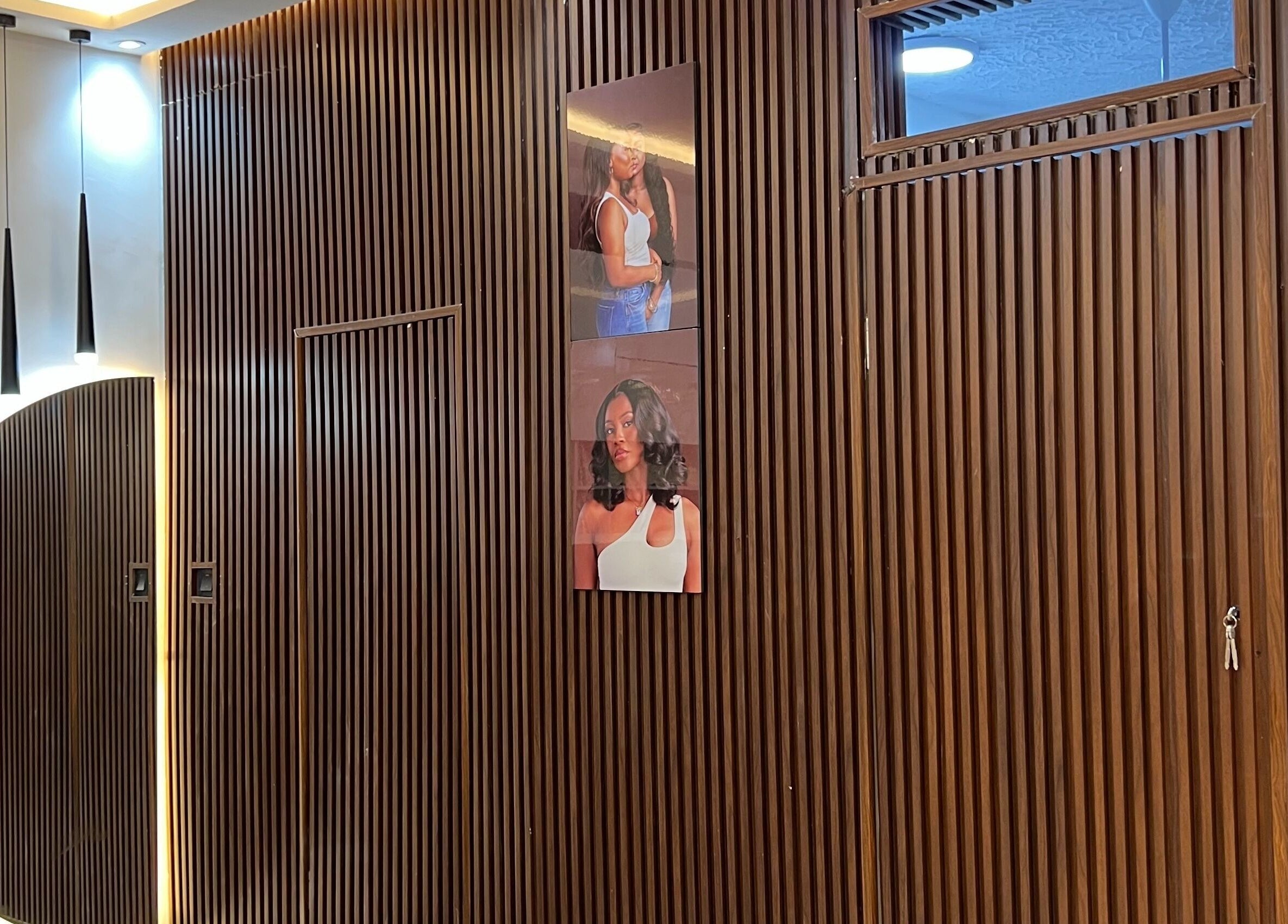 Stylish wooden wall with modern lighting at Wighub & Salon, Accra, Greater Accra Region, GH.