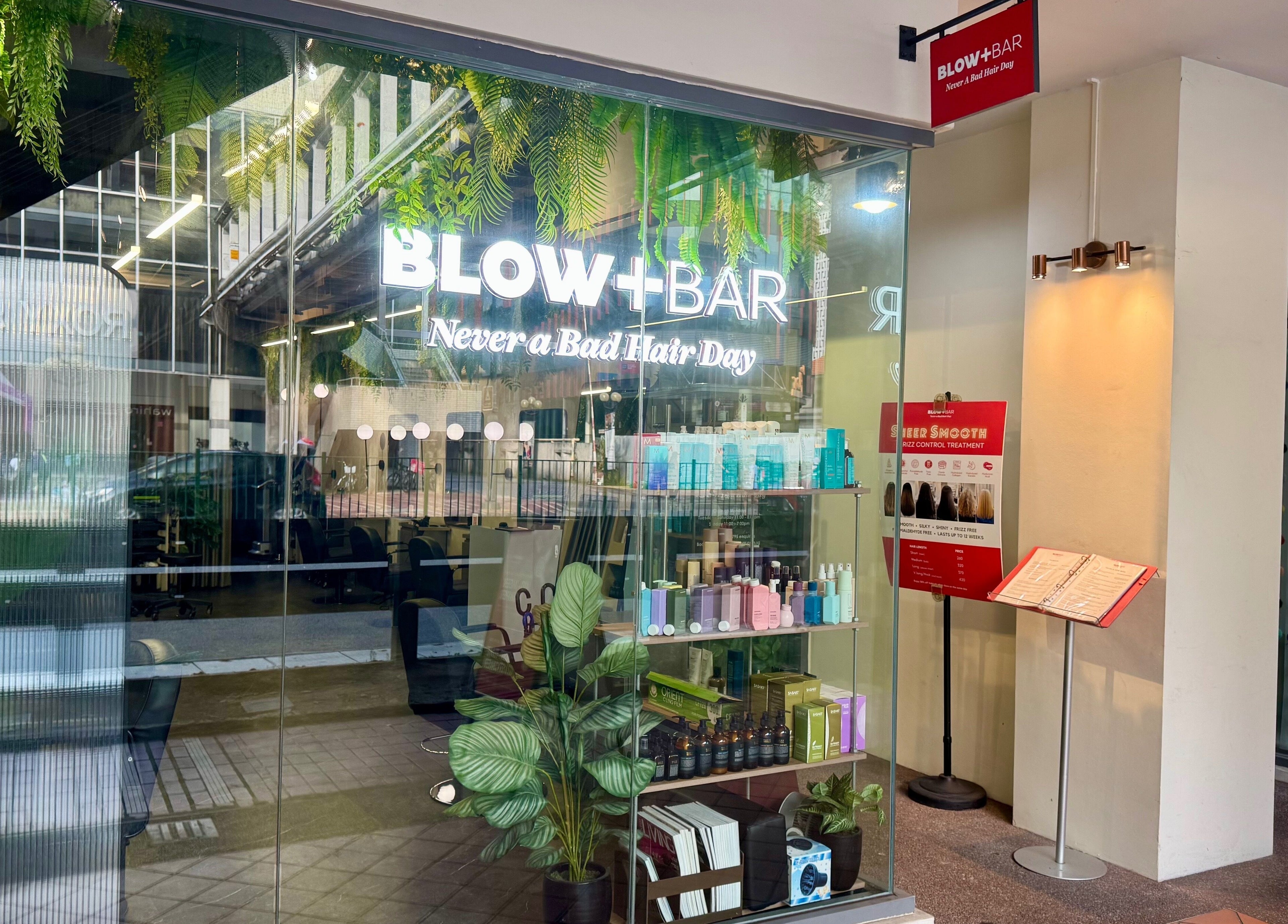 Chic Blow+Bar entrance in Singapore, featuring stylish decor and beauty products on display.