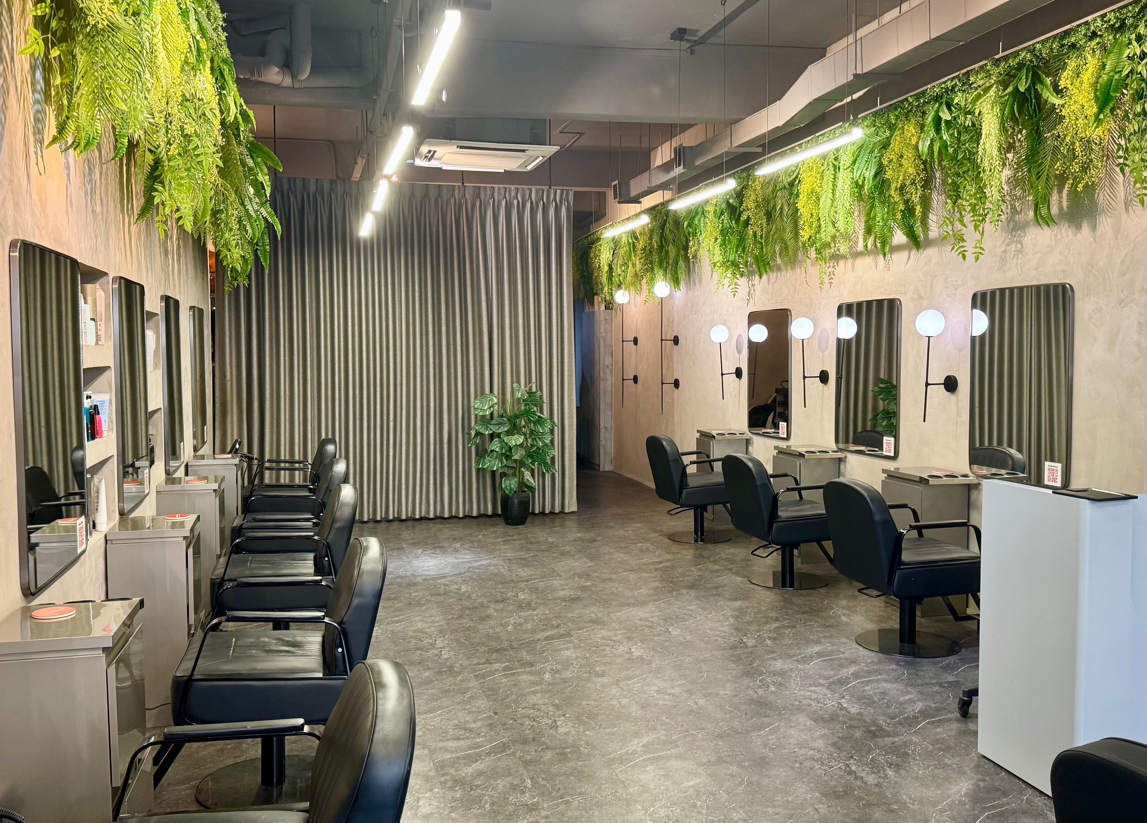 Chic interior of Blow+Bar in Singapore, SG with stylish chairs, mirrors, and greenery creating a serene atmosphere.