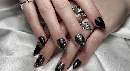 Elegant black nail art from Medusa’s Mantra, Greenbank, Queensland, AU. Silver rings add a stylish touch.
