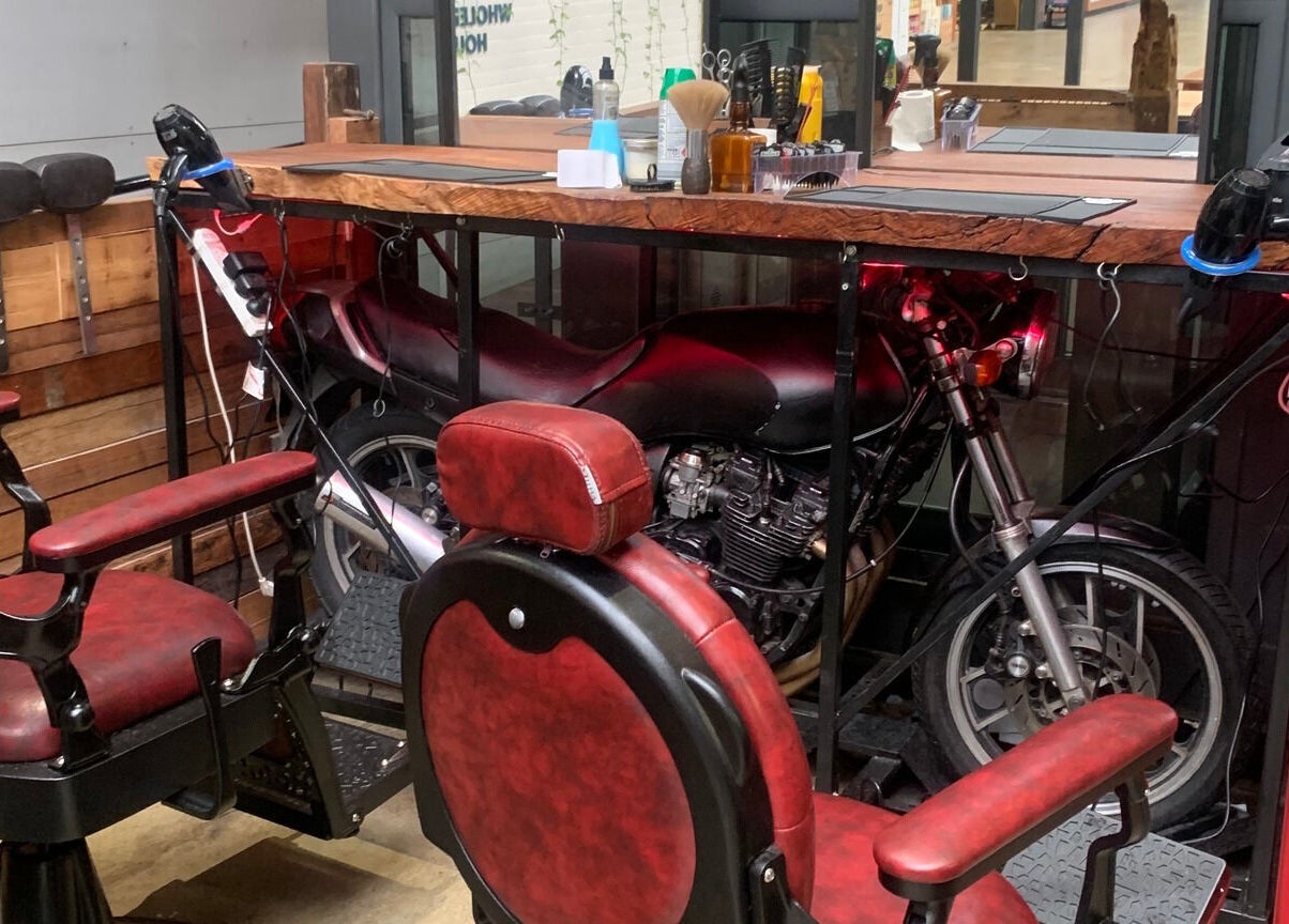Vintage barber chairs and motorcycle decor at Tapperdon Barbershop, Rosebery, New South Wales, AU.