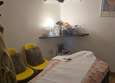 Cozy massage room at WS Thai Table Massage, Croydon, England, GB with yellow chairs and soothing decor.