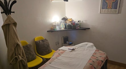 Cozy massage room at WS Thai Table Massage, Croydon, England, GB with yellow chairs and soothing decor.