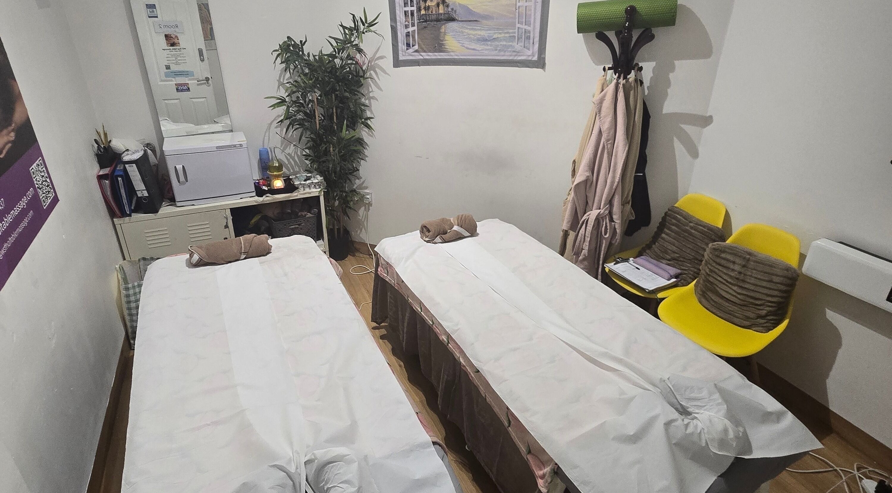 Relaxing double massage room at WS Thai Table Massage, Croydon, England, GB featuring two treatment beds.