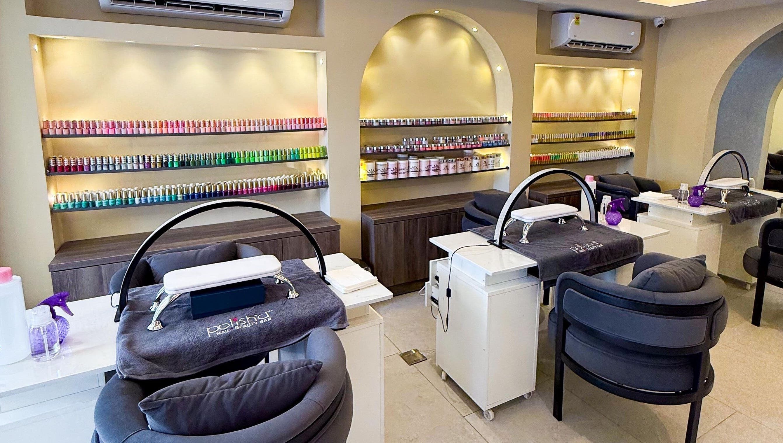 Polish’d Nails and Beauty Bar, Accra: Elegant nail salon interior with vibrant polish display and plush seating.