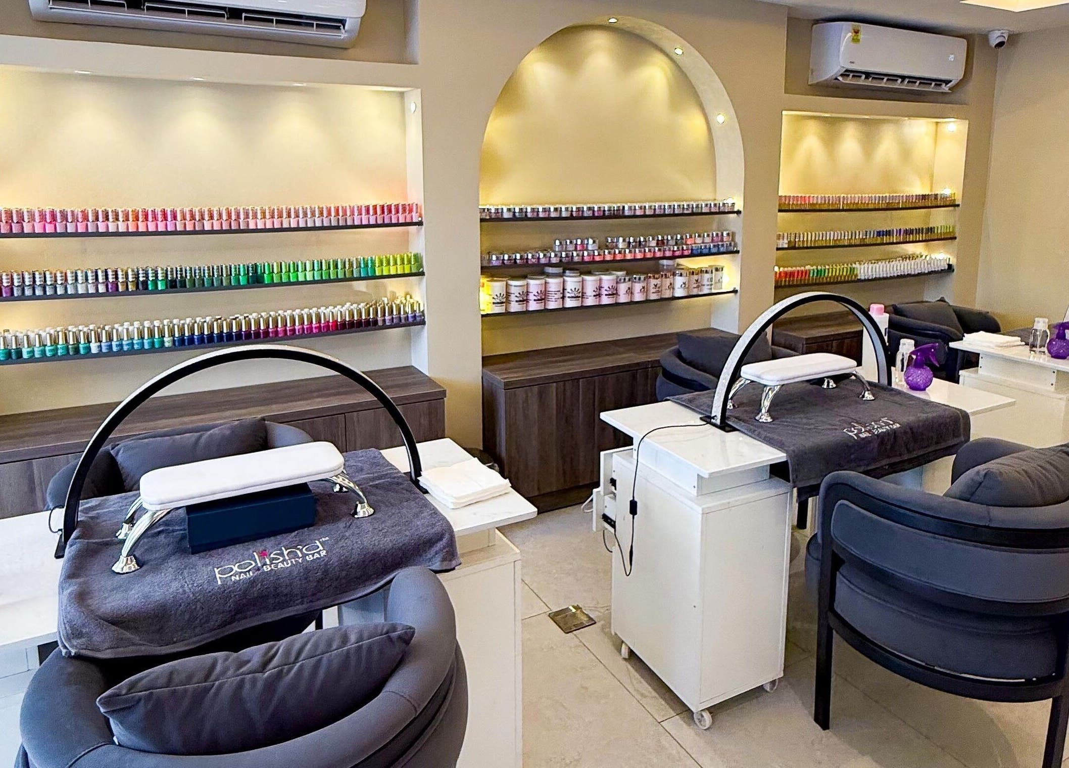 Polish’d Nails and Beauty Bar, Accra: Elegant nail salon interior with vibrant polish display and plush seating.
