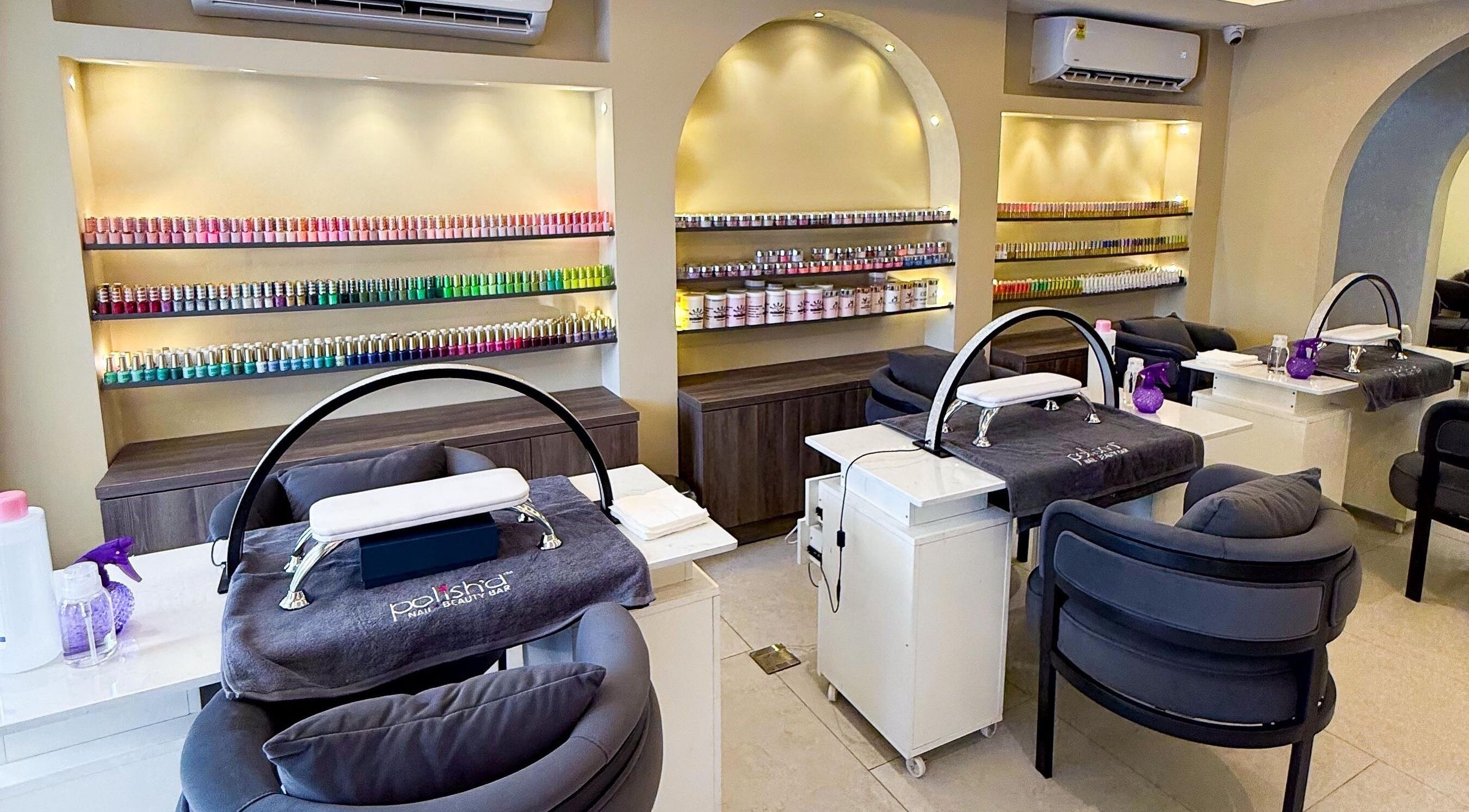 Polish’d Nails and Beauty Bar, Accra: Elegant nail salon interior with vibrant polish display and plush seating.
