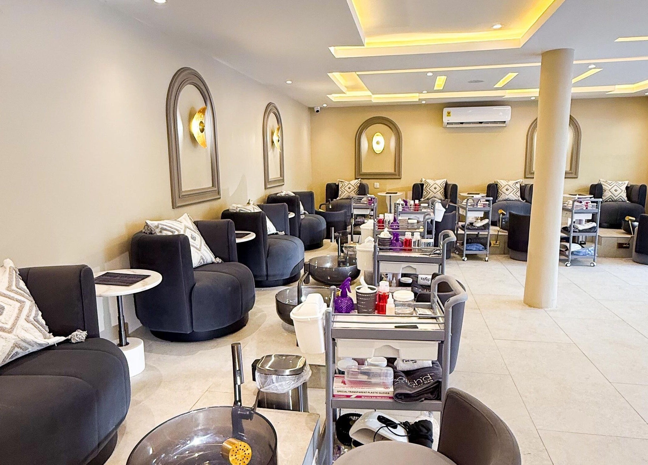 Spacious interior of Polish’d Nails and Beauty Bar in Accra, showcasing modern seating and decor for relaxation.