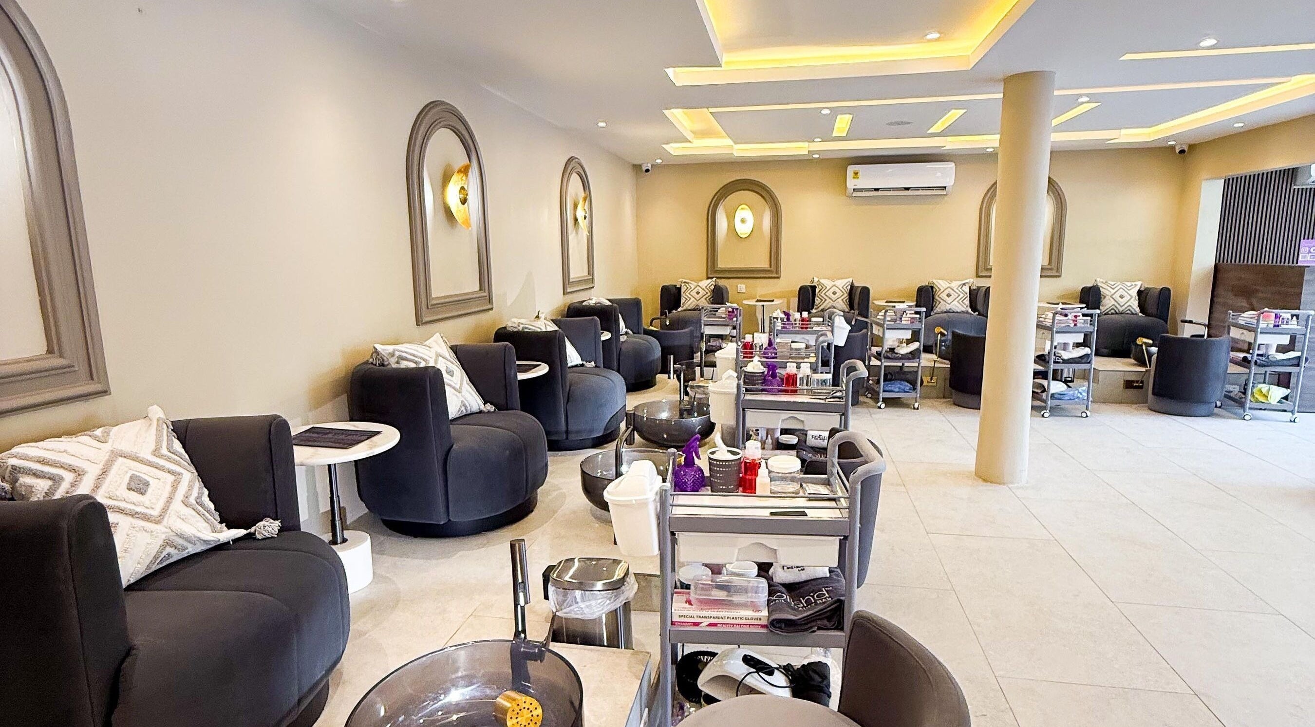 Spacious interior of Polish’d Nails and Beauty Bar in Accra, showcasing modern seating and decor for relaxation.