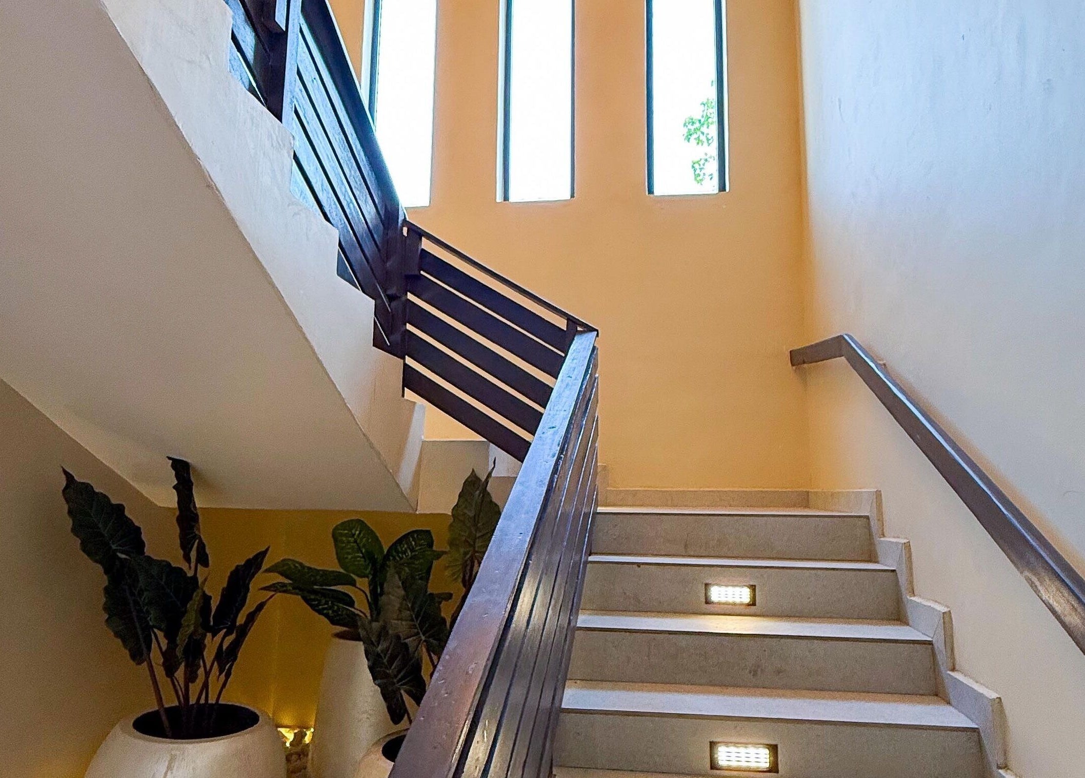 Elegant stairway at Polish’d Nails and Beauty Bar in Accra, Greater Accra Region, GH with natural lighting.