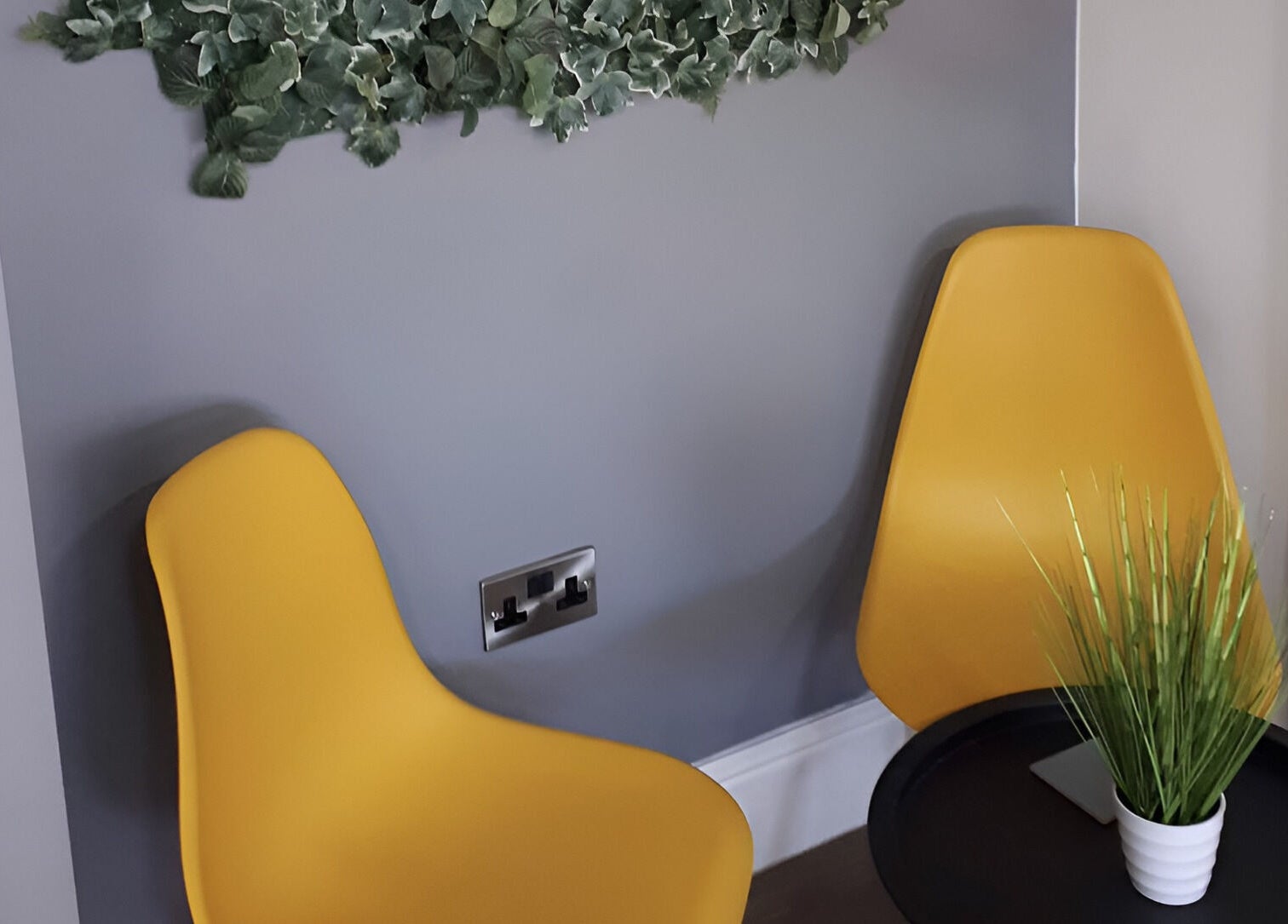 Modern yellow chairs with greenery at RBST+ Barber Shop, Horwich, England, GB.