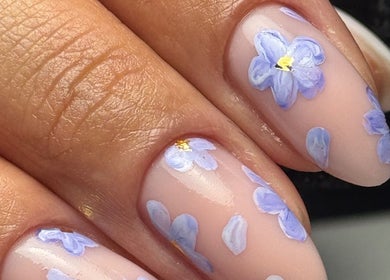 Beautiful floral nail art at Burjuwanails in Lyndhurst, New Jersey, US, featuring delicate purple flower designs.