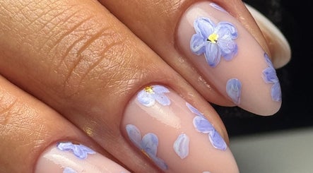 Beautiful floral nail art at Burjuwanails in Lyndhurst, New Jersey, US, featuring delicate purple flower designs.