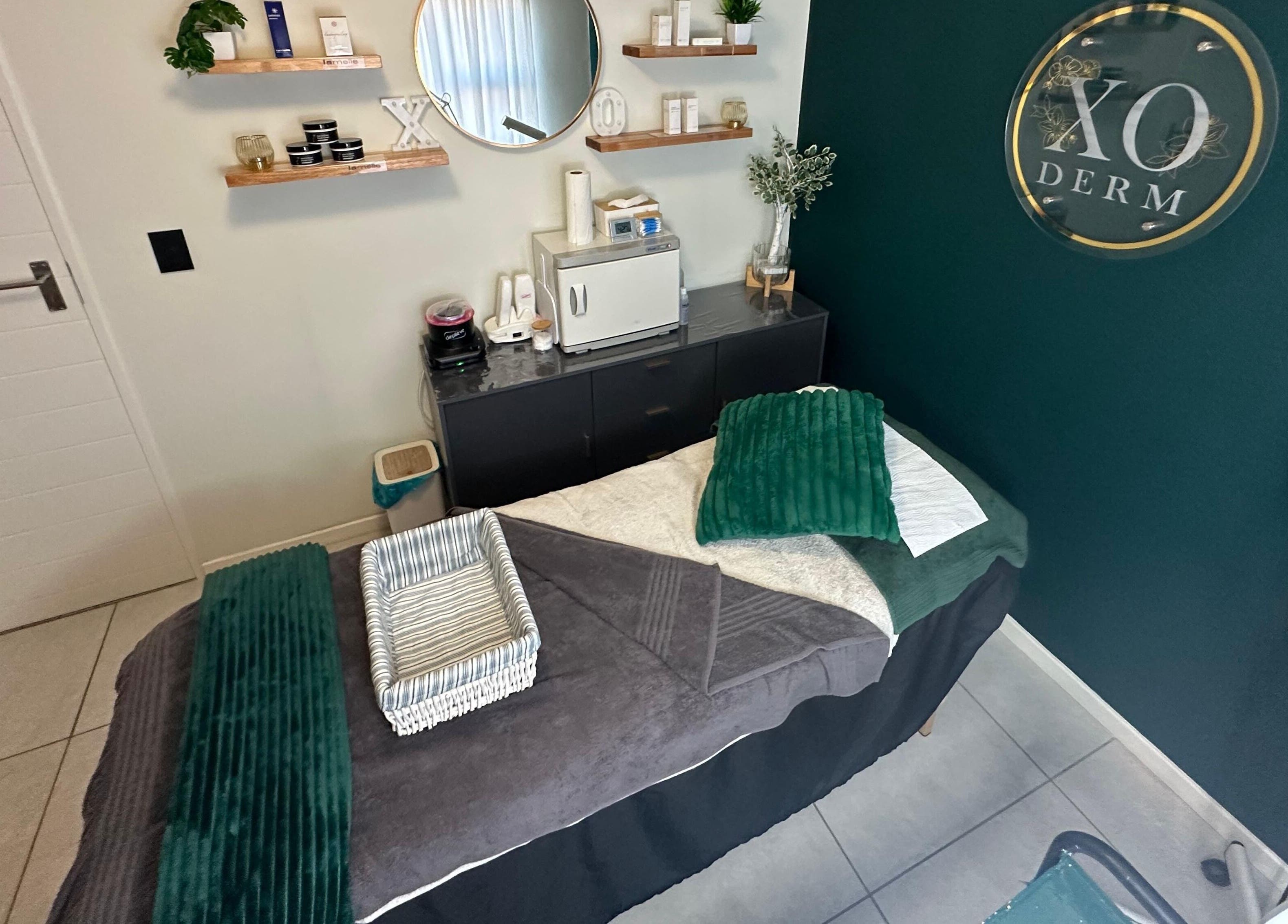 Relaxing treatment room at XODERM in Centurion, Gauteng, ZA, featuring a cozy massage bed and calming decor.