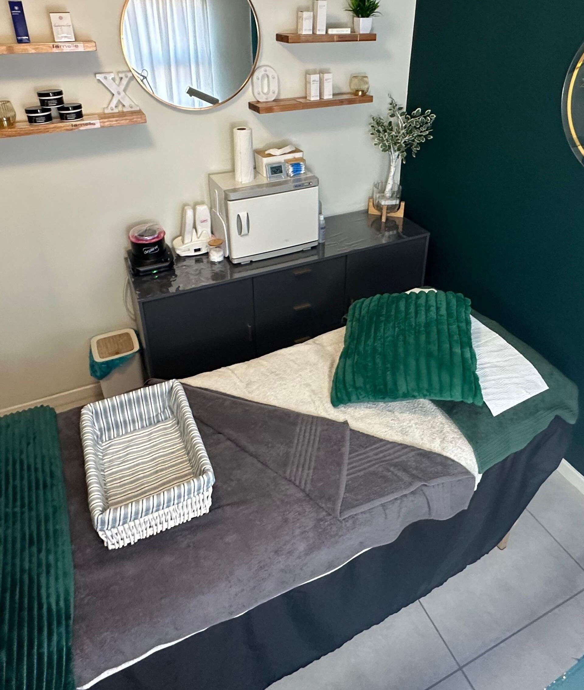 Relaxing treatment room at XODERM in Centurion, Gauteng, ZA, featuring a cozy massage bed and calming decor.