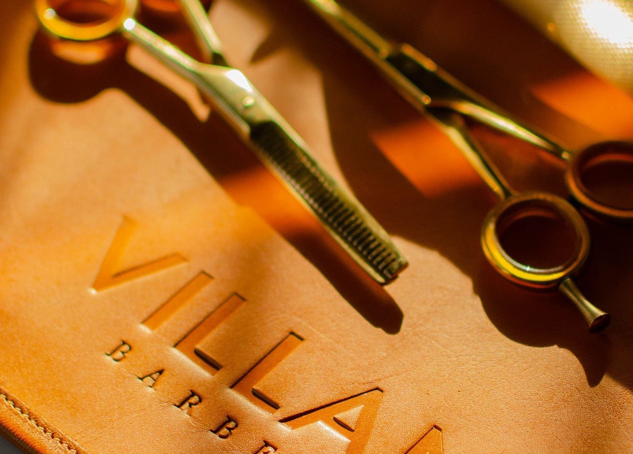 Golden barber shears on leather at VILLANO SAN MIGUEL, San Miguel De Allende, Guanajuato, MX.