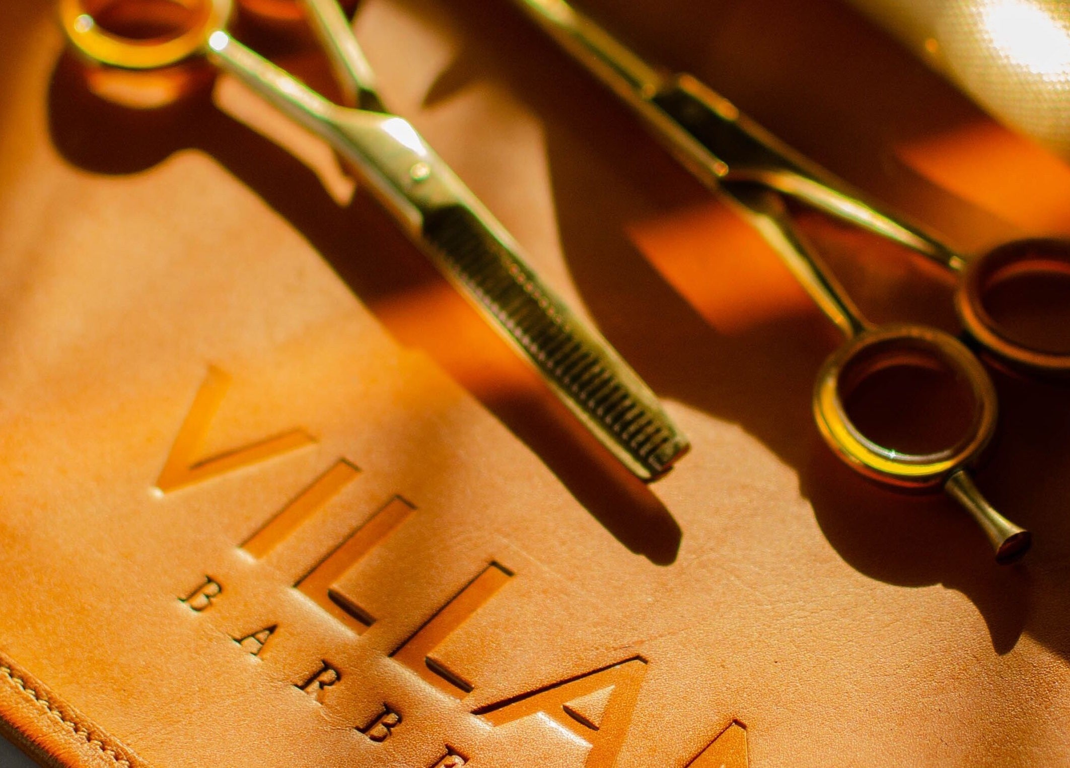 Golden barber shears on leather at VILLANO SAN MIGUEL, San Miguel De Allende, Guanajuato, MX.