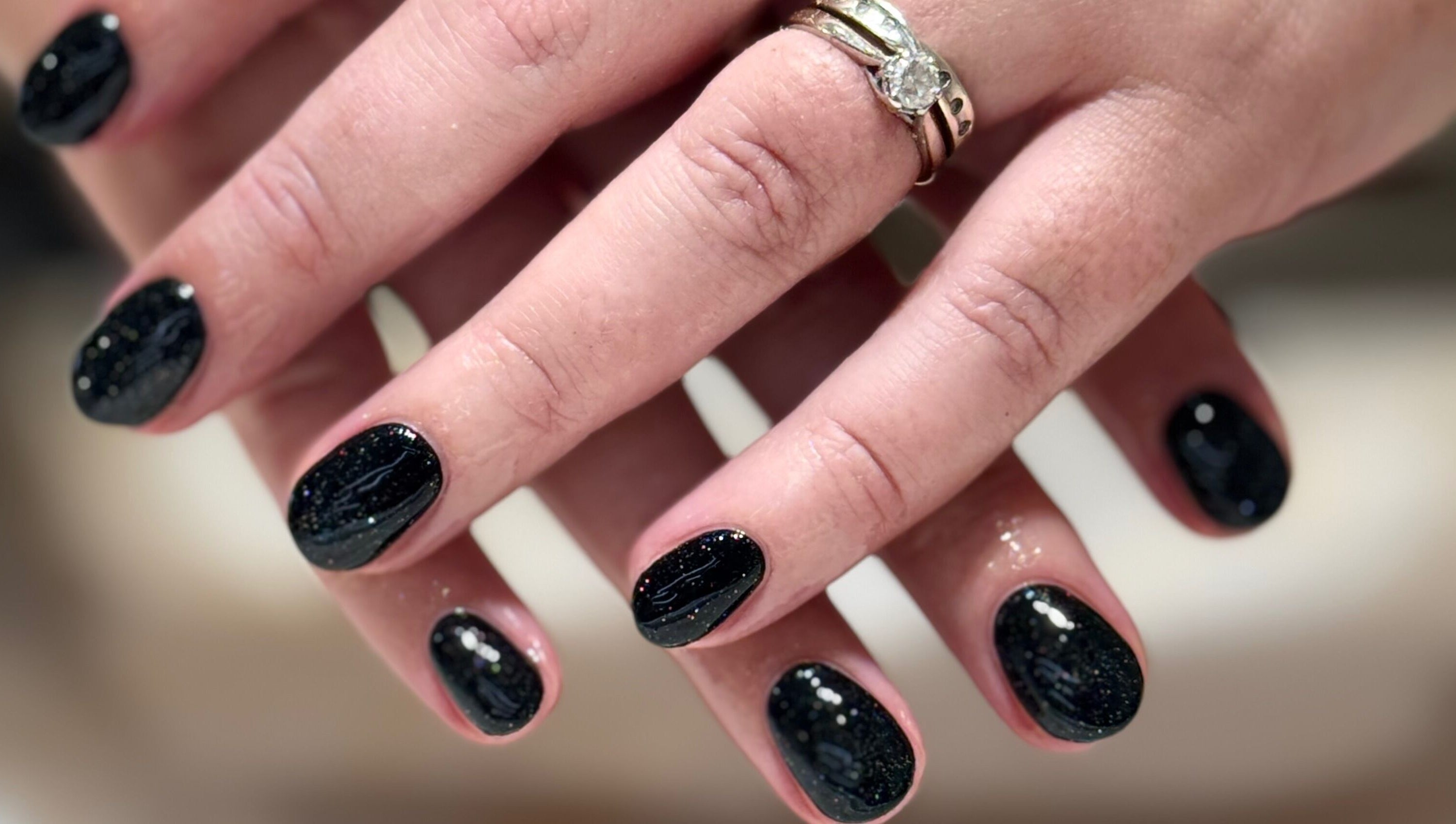 Close-up of glittery black manicure at Solie Studios in Bristol, England, GB.