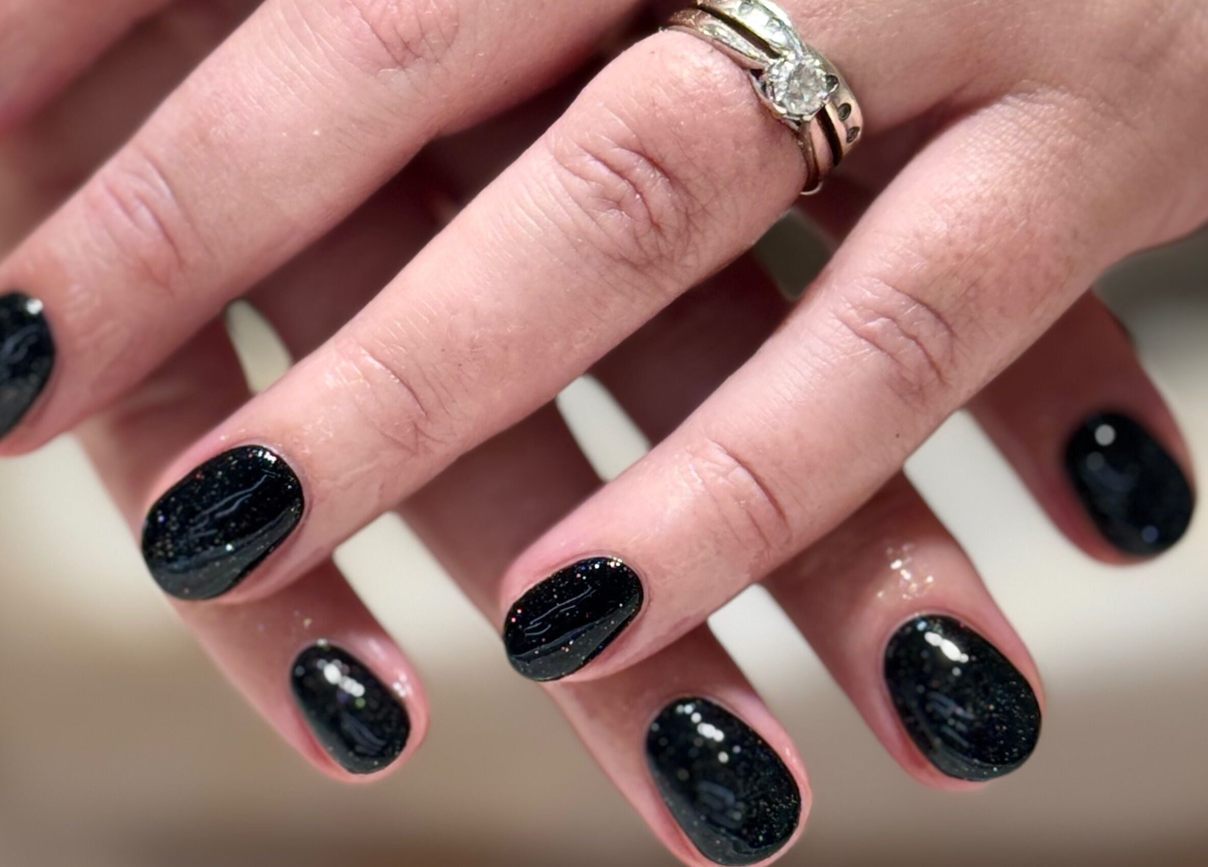 Close-up of glittery black manicure at Solie Studios in Bristol, England, GB.