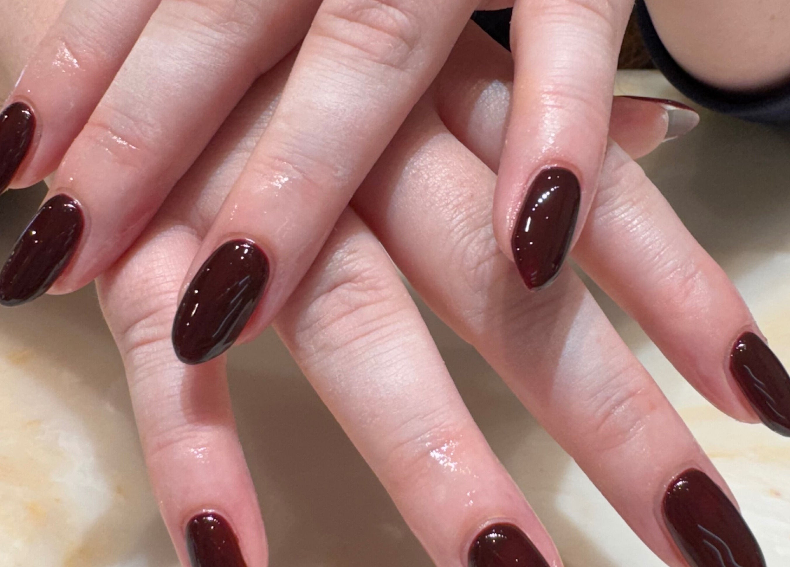 Beautifully manicured nails with rich crimson polish at Solie Studios, Bristol, England, GB.