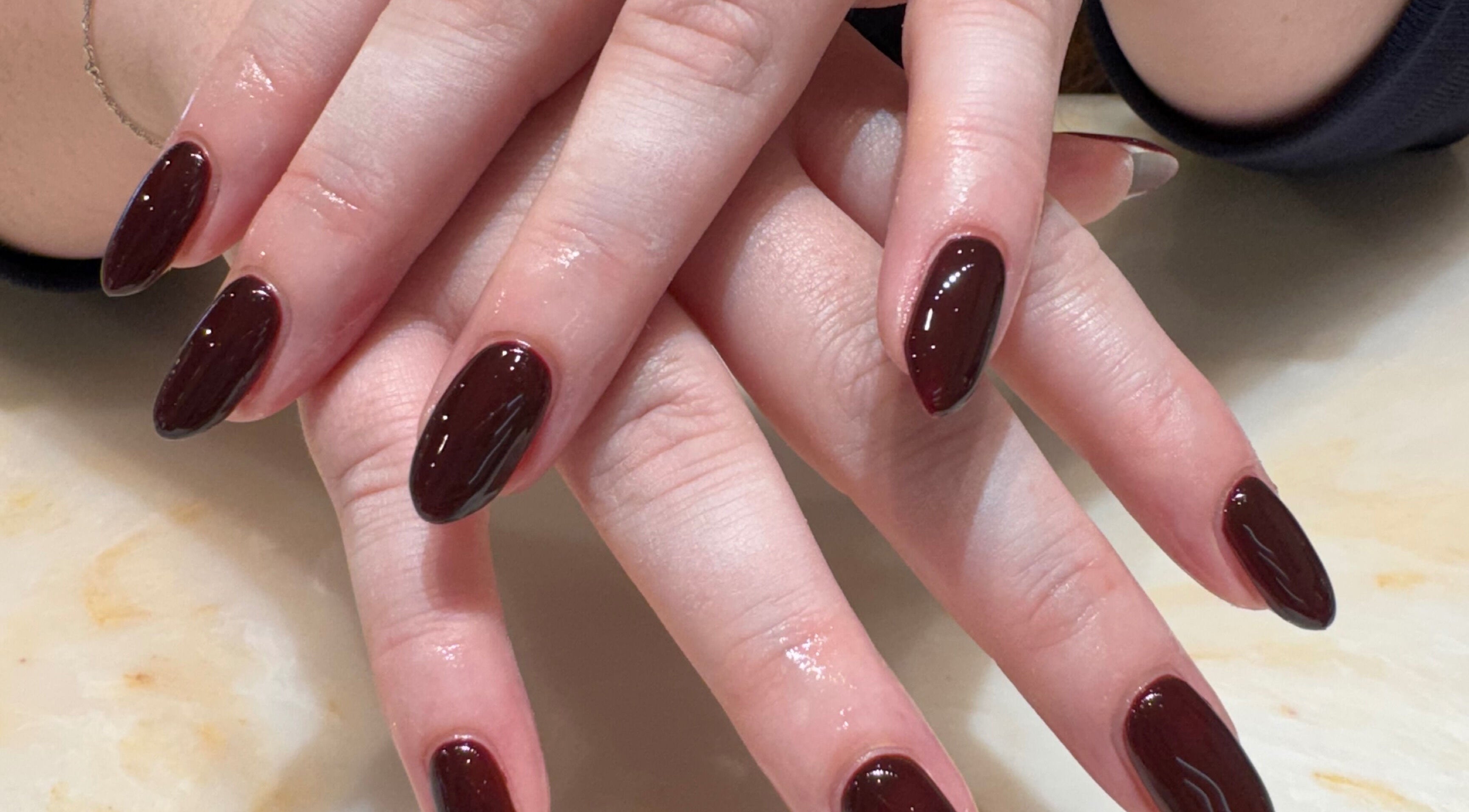 Beautifully manicured nails with rich crimson polish at Solie Studios, Bristol, England, GB.