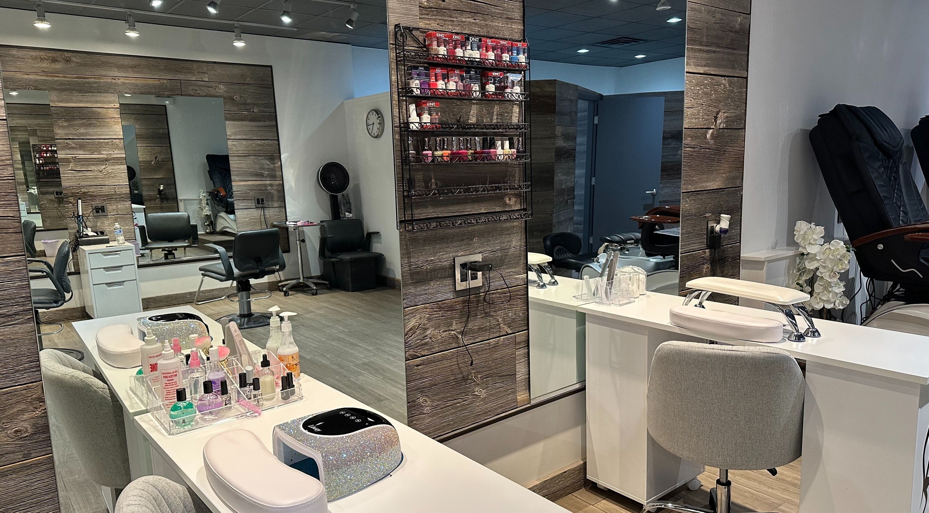 Modern interior of Eda Salon&Spa in Chicago, Illinois, US showcasing stylish nail stations and hair care areas.
