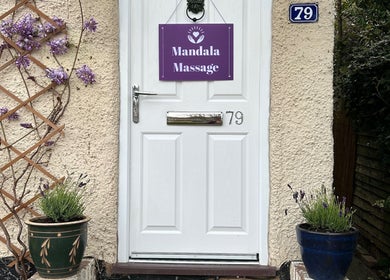 Front entrance of Mandala Massage in Berkhamsted, England, GB with lavender pots and a welcoming sign.