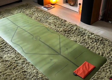 Green yoga mat in cozy setting at Mandala Massage, Berkhamsted, England, GB.