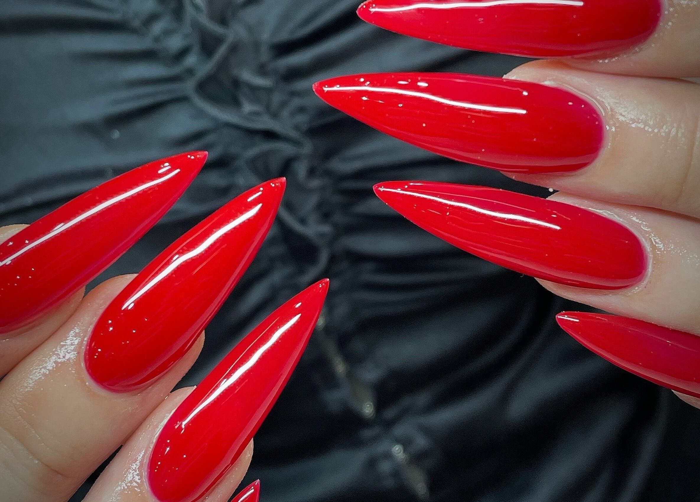Red stiletto nails featured at Jade Top Nails Hair Beauty Salon, Melbourne, Victoria, AU.