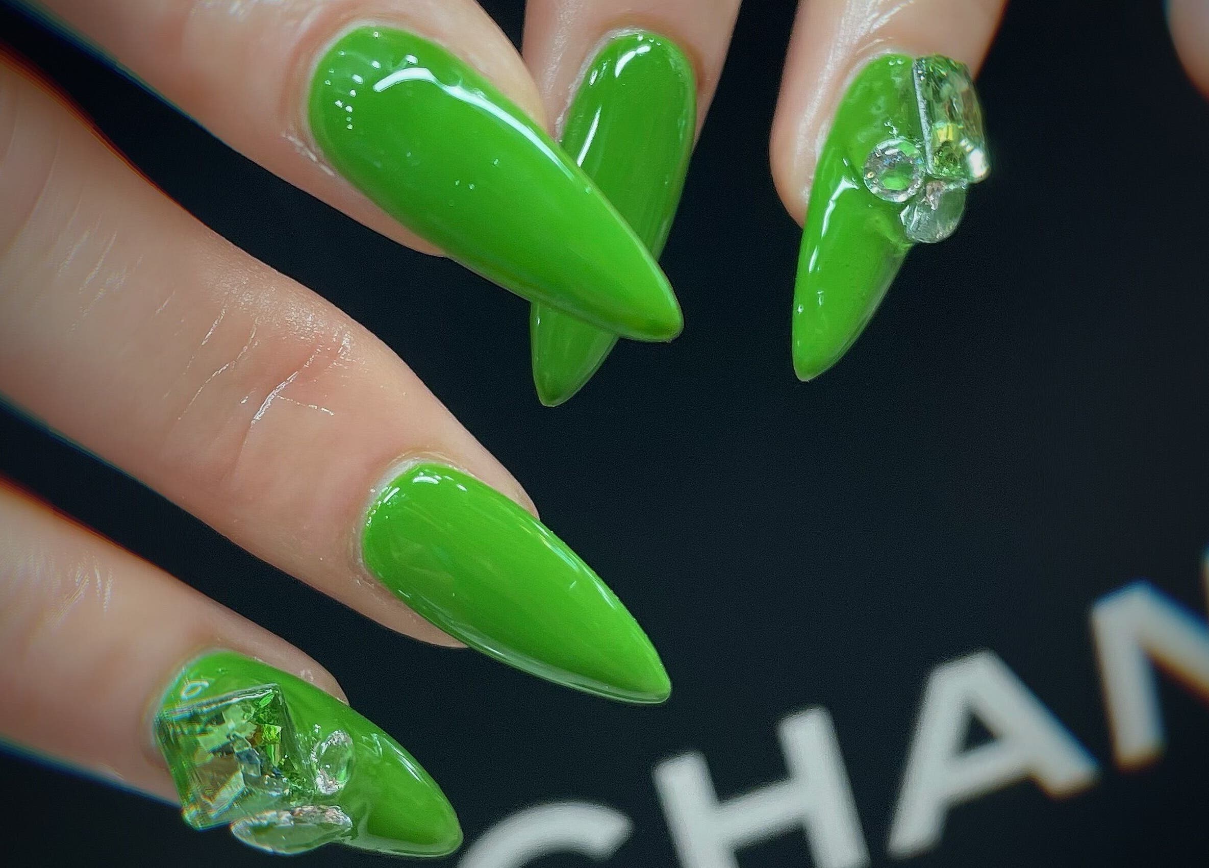 Bright green acrylic nails with gems from Jade Top Nails Hair Beauty Salon, Melbourne, Victoria, AU.
